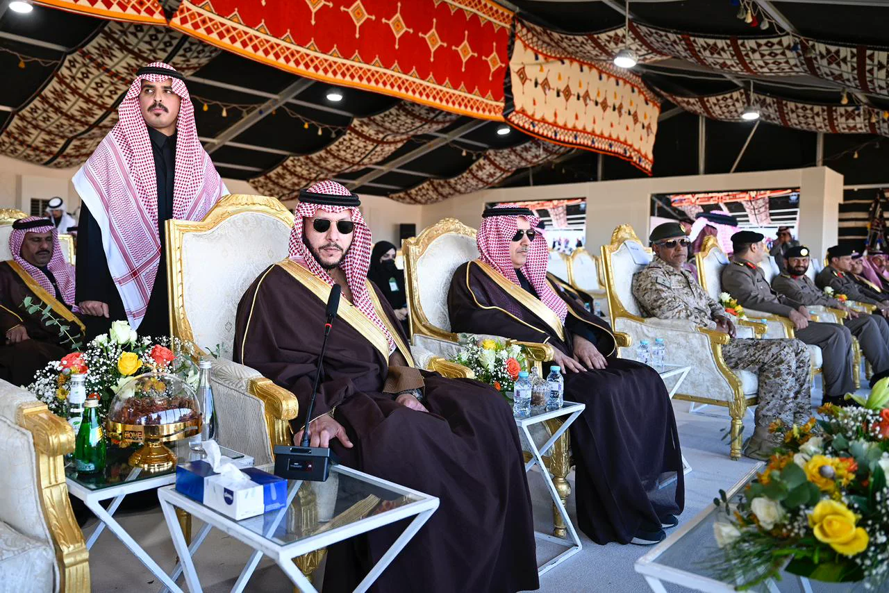 Dignitaries in traditional regalia seated beneath a gilded ceremonial tent
