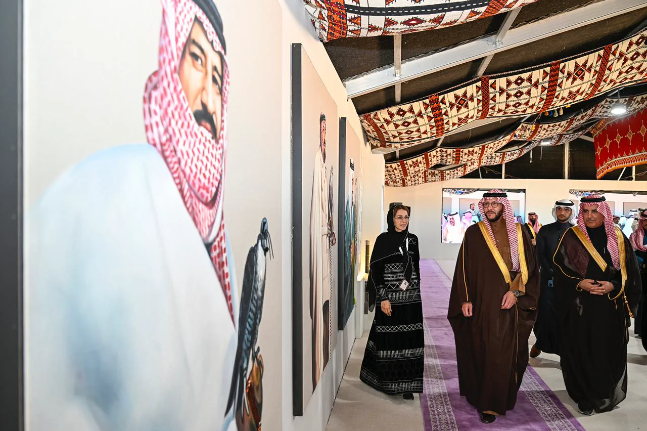 Leadership walking through a corridor of heritage artworks