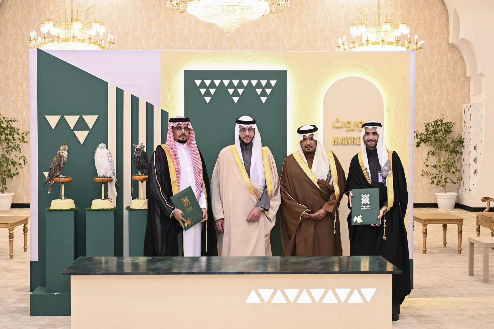 Partners gathered with signed agreements at the branded Mawroth pavilion