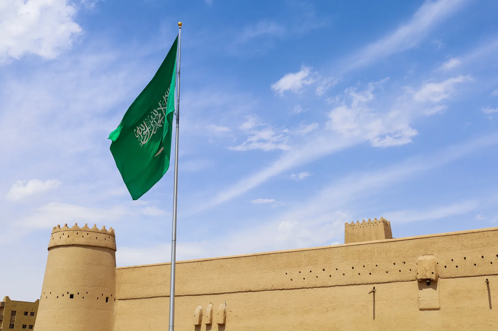 Saudi national flag flying over Al-Masmak Palace ramparts, Riyadh