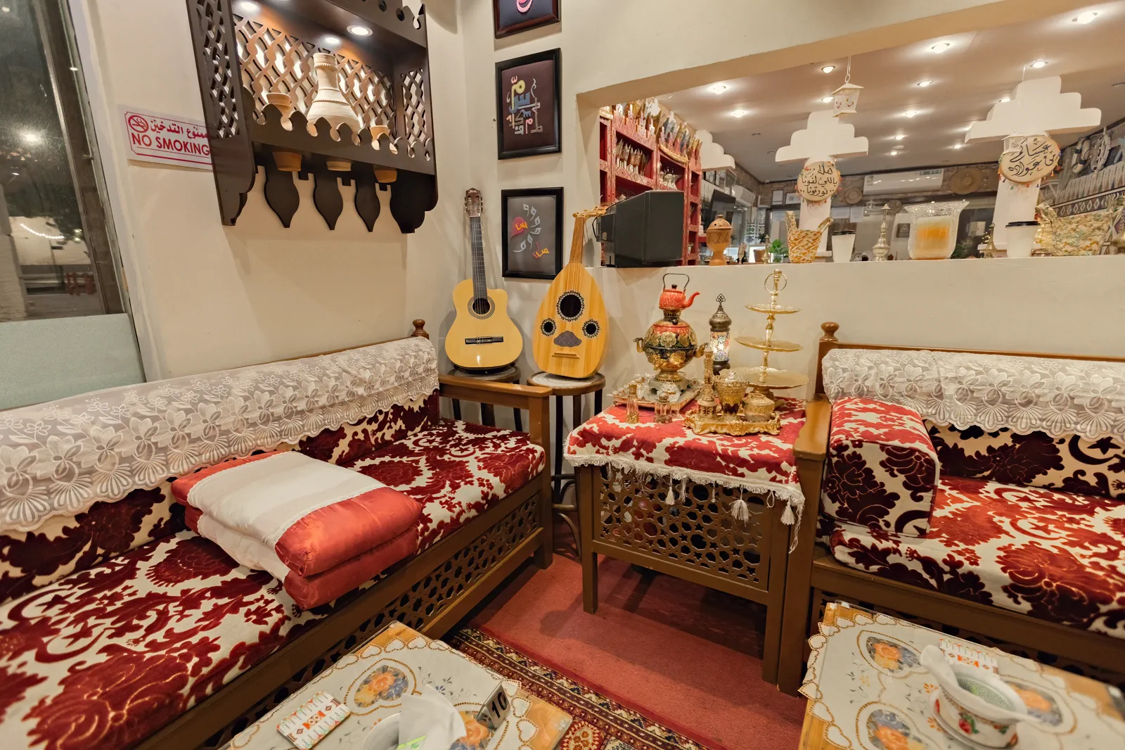 Traditional Saudi coffee-house interior with oud, incense set and red rugs, Jeddah