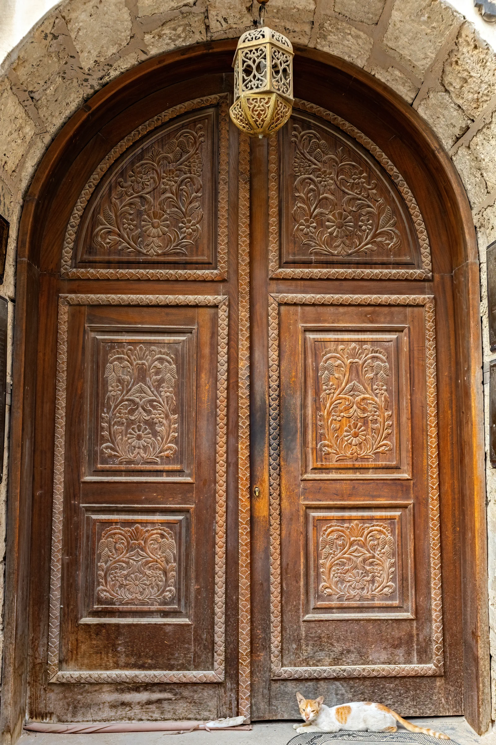 Ornate carved arched wooden door with hanging lantern, Al-Balad Jeddah